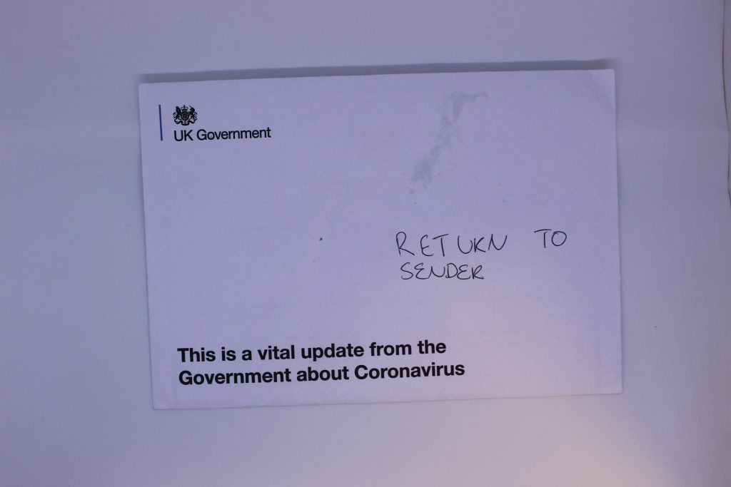 STOPM_2020_399a: White envelope with the printed text ‘UK Government’ and ‘This is a vital update from the UK Government about Coronavirus’. The envelope has been written on with black biro, ‘RETURN TO SENDER’. 