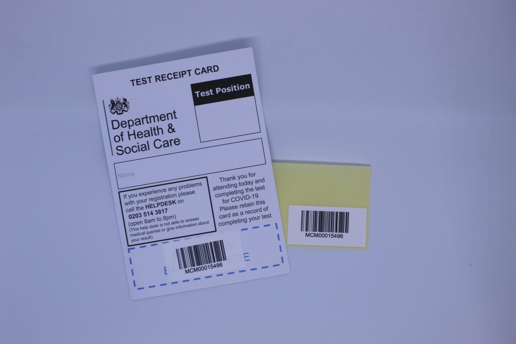 STOPM_2020_400b: Barcode sticker on backing paper, and the test receipt card with the barcode sticker on. 